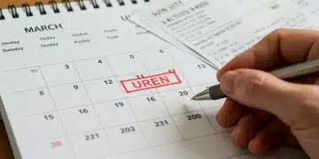 Calendar highlighting March deadline next to utility bills with a hand holding a pen, symbolizing urgent LIHEAP application